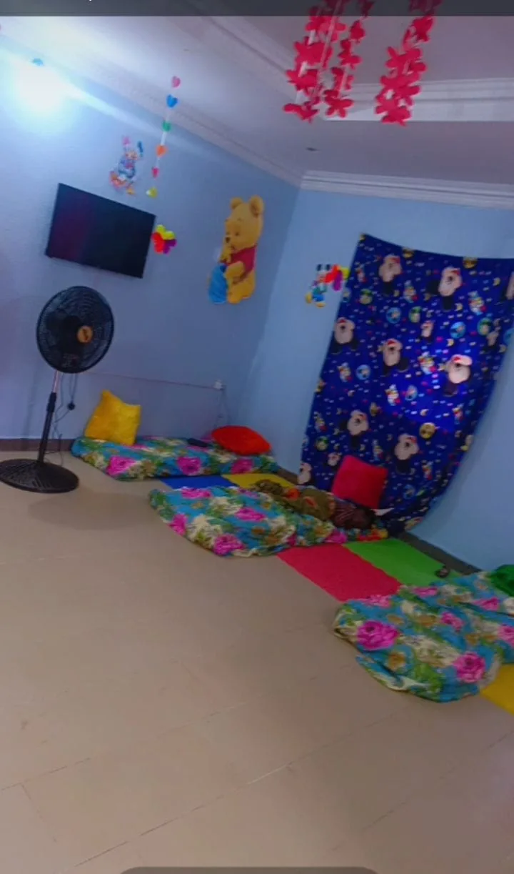 Crèche rest area with cushioned mats and colourful curtains