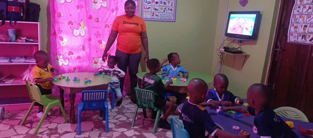 Children working with colourful learning materials at classroom tables