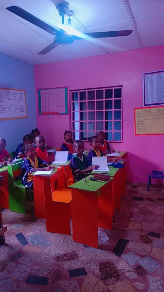 Primary pupils working in exercise books at their desks